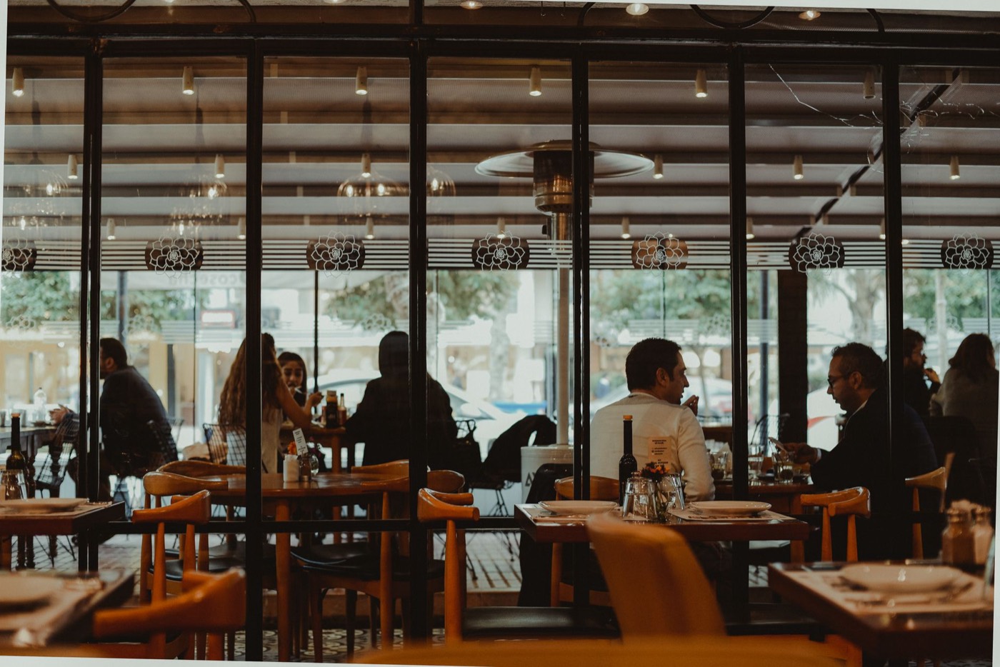 Warm restaurant dining room with wooden tables